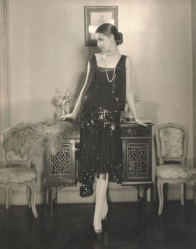 Marion_Morehouse_wearing_a_black_crepe_romain_bolero_dress_with_fringed_and_paillette_embroidered_skirt_by_Chanel._Published_in_Vogue_US_1926._Edward_SteichenCond_NastShutterstu_-_Copy.JPG